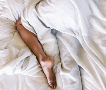 a person laying in bed, getting better sleep based on their unique temperament